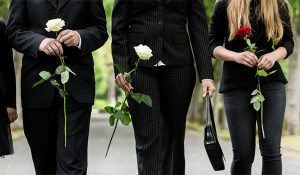 torsos of family mourning a child at a funeral