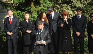 Mourners at a funeral wearing all black.